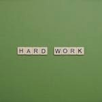 Hard Work Text On Green Background