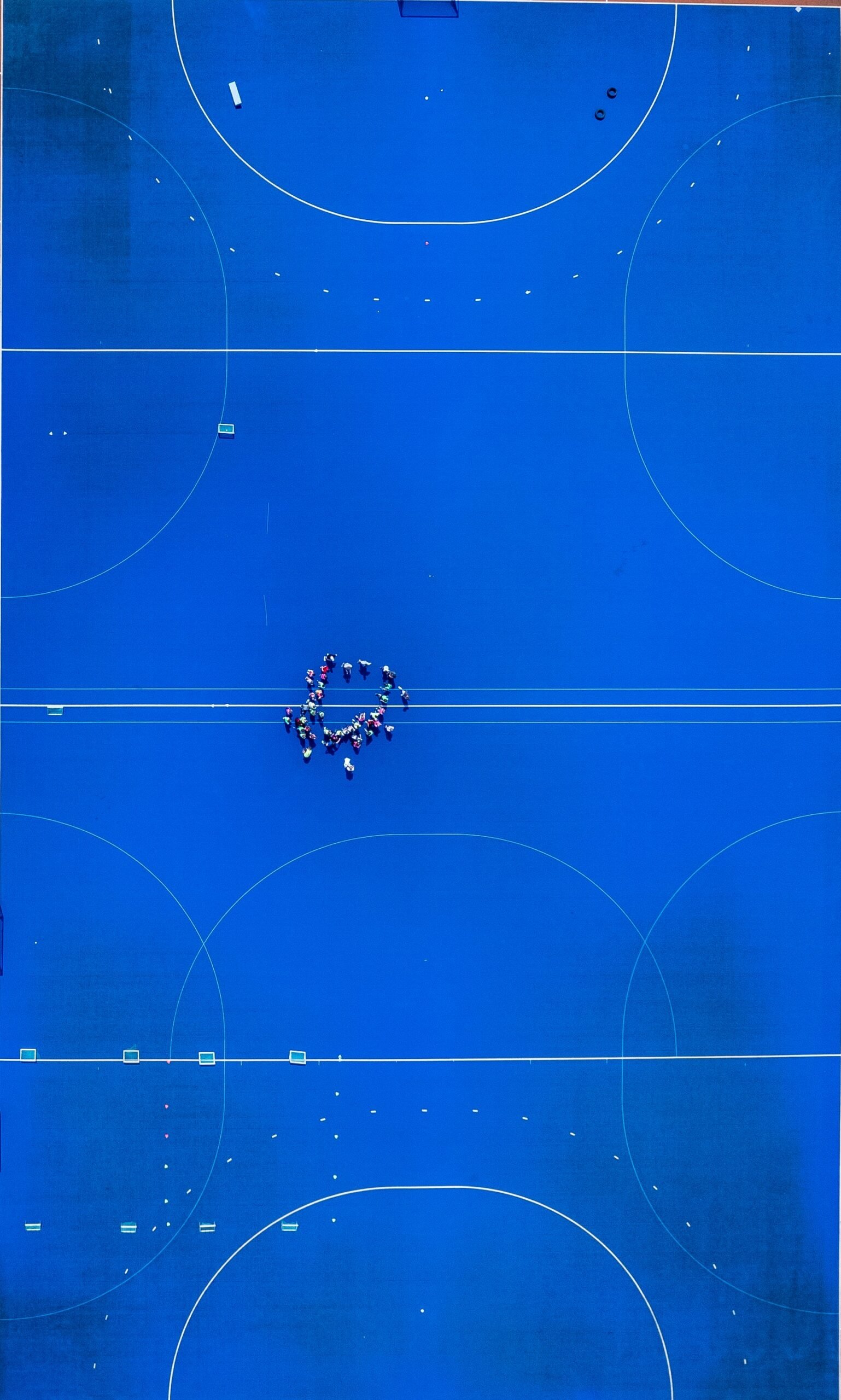 An overhead view of a blue basketball court