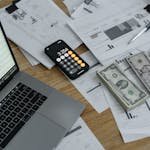 Banknotes and Calculator on Table