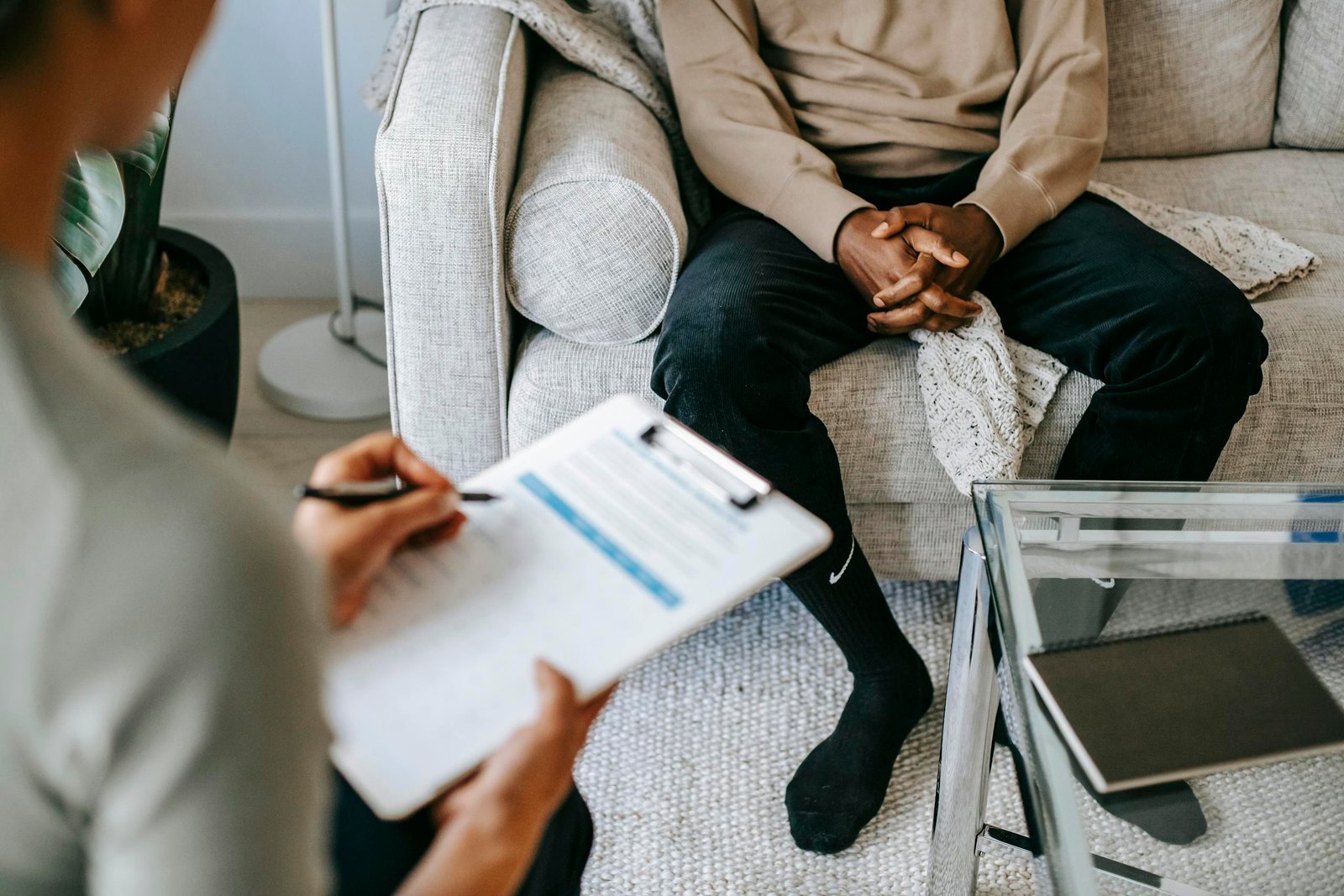 Crop ethnic client discussing problems with anonymous psychologist