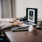 Selective Focus Photography of Woman Using Macbook Pro