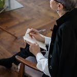 Woman in Black Blazer Holding White Tablet Computer