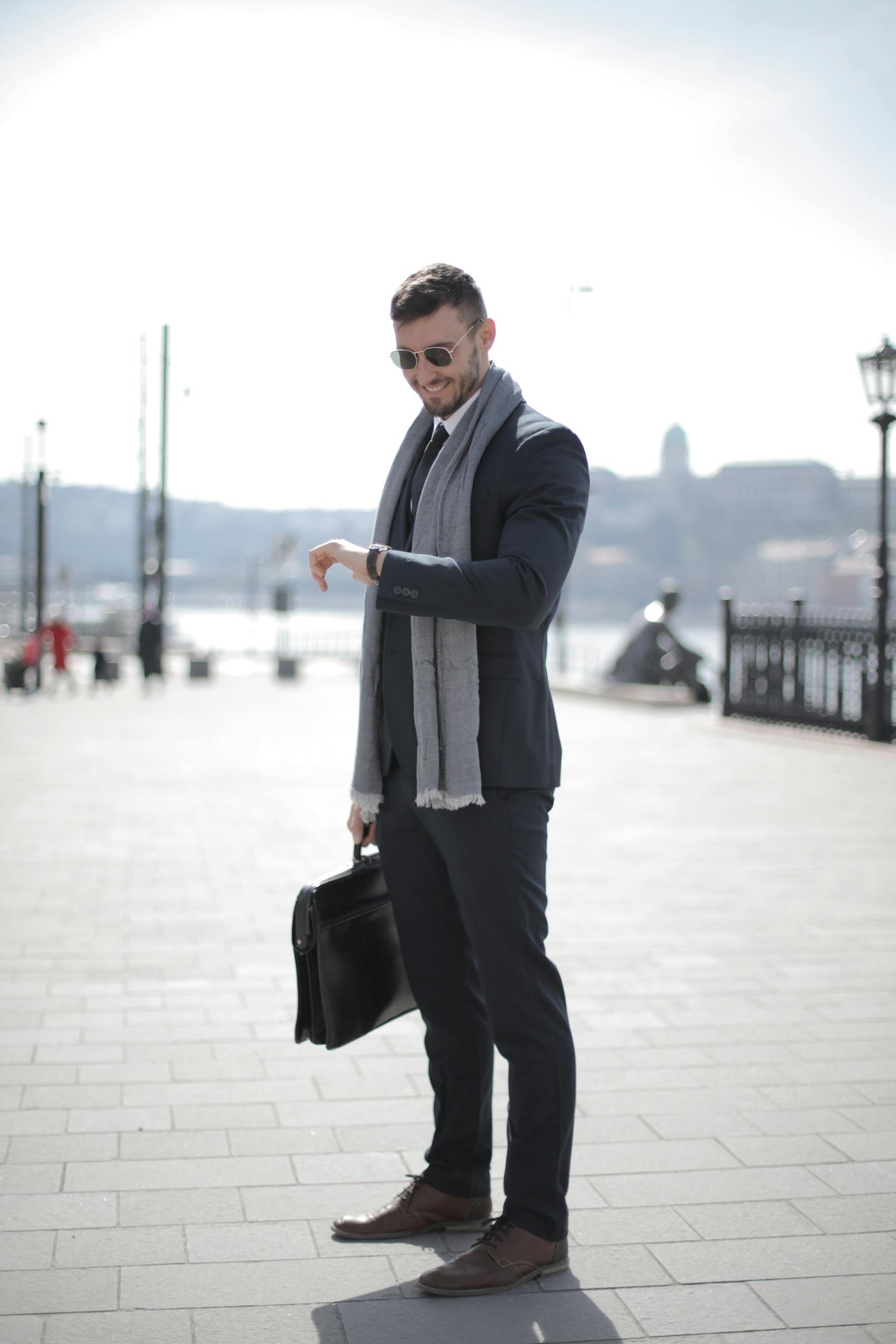 Man in Black Suit Holding Leather Briefcase