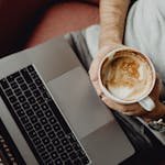 Man with Laptop on Laps and Coffee